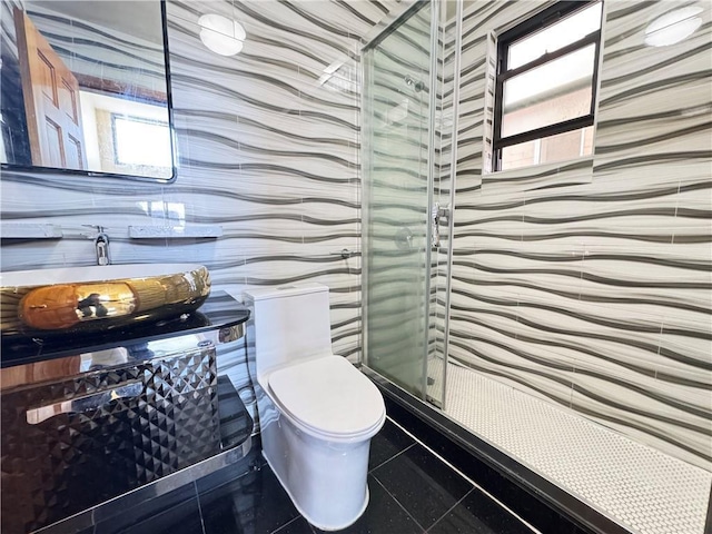 bathroom featuring a stall shower and toilet