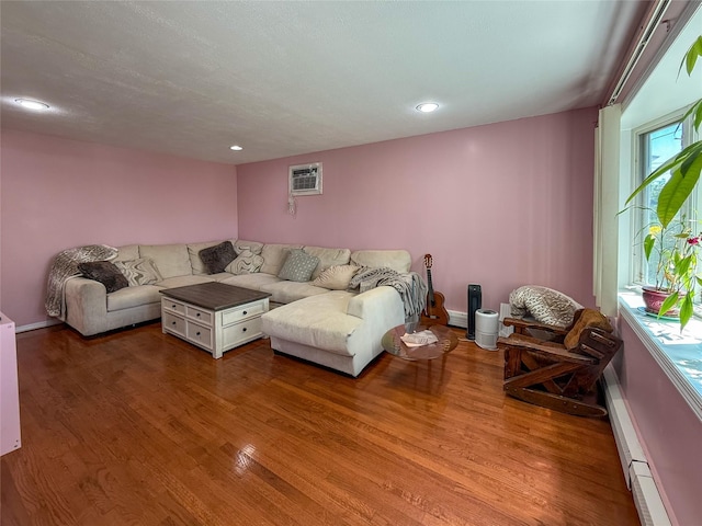 1 Palmer Pl, Valley Stream, NY 11580 - living area with wood finished floors, a baseboard radiator, a wall mounted AC, recessed lighting, and baseboards