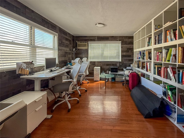 1 Palmer Pl, Valley Stream, NY 11580 - home office with a textured ceiling, wooden walls, wood finished floors, and a wall unit AC