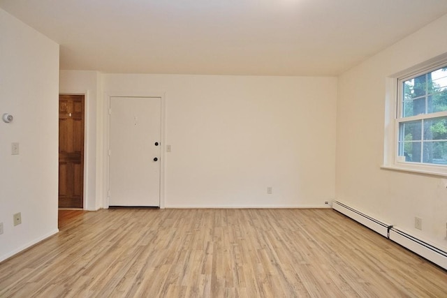 11 The Blvd Unit A4, Cold Spring, NY 10516 - empty room with a baseboard heating unit, light wood-style floors, and baseboards