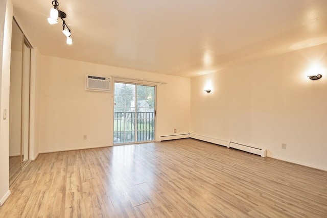 11 The Blvd Unit A4, Cold Spring, NY 10516 - unfurnished room with light wood-style floors, a wall mounted AC, baseboards, and a baseboard radiator