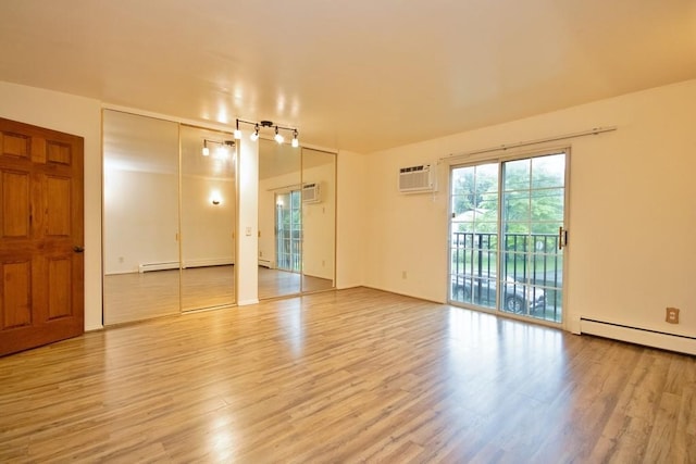 11 The Blvd Unit A4, Cold Spring, NY 10516 - unfurnished room featuring light wood-style flooring, a wall mounted air conditioner, and a baseboard radiator
