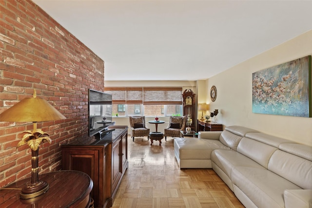 living area featuring brick wall
