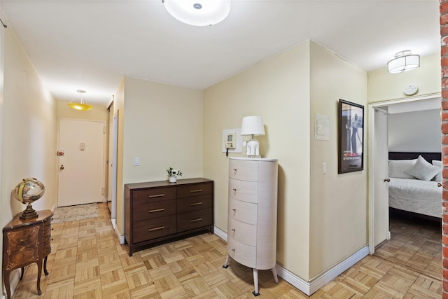 hall featuring baseboards