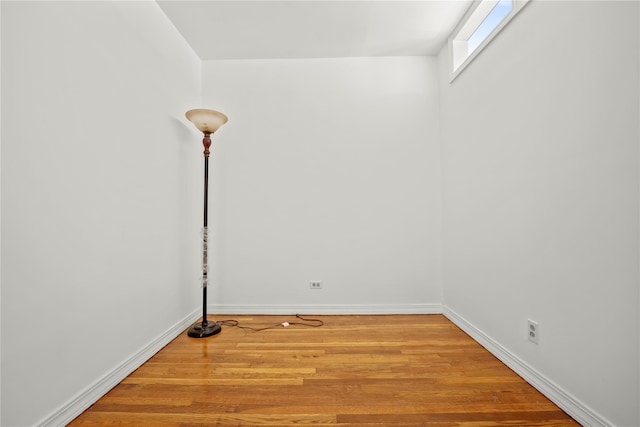 unfurnished room featuring wood finished floors and baseboards
