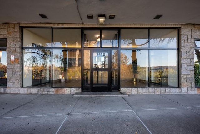 property entrance with stone siding