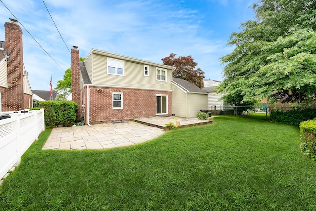11 Durham Rd, New Hyde Park, NY 11040 - rear view of house with brick siding, a patio area, and a chimney