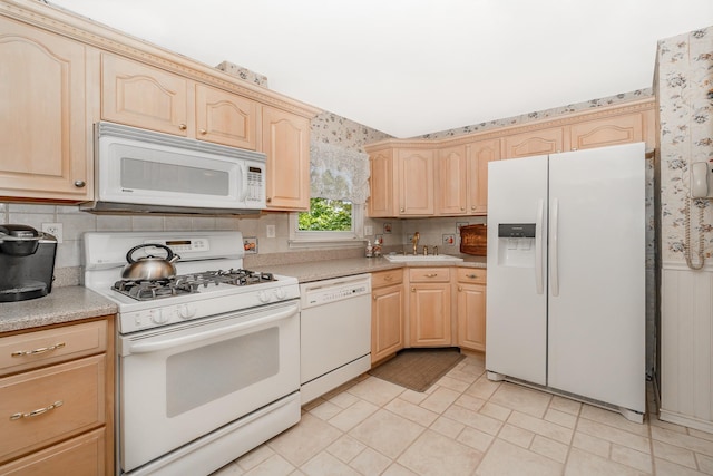 11 Durham Rd, New Hyde Park, NY 11040 - kitchen with white appliances, light brown cabinets, light countertops, a sink, and wallpapered walls