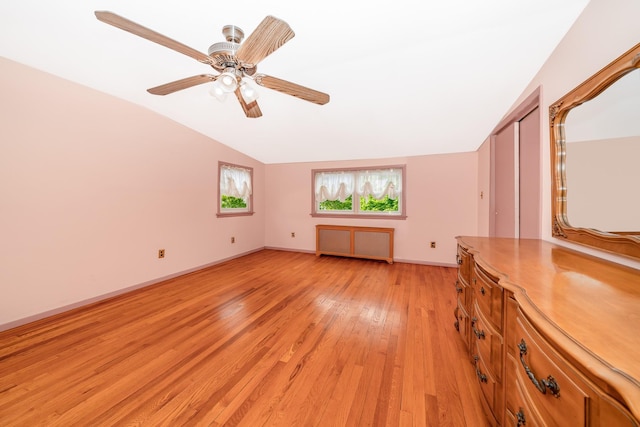 11 Durham Rd, New Hyde Park, NY 11040 - empty room featuring radiator heating unit, vaulted ceiling, light wood-style floors, baseboards, and a ceiling fan