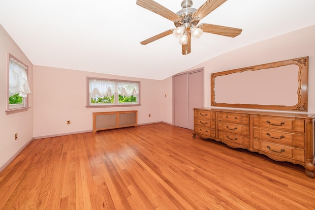 11 Durham Rd, New Hyde Park, NY 11040 - unfurnished bedroom featuring lofted ceiling, light wood finished floors, radiator, a ceiling fan, and a closet
