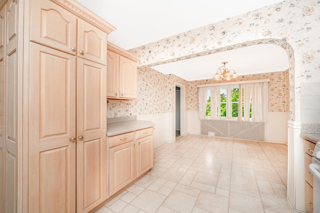 11 Durham Rd, New Hyde Park, NY 11040 - kitchen featuring wallpapered walls, a wainscoted wall, a chandelier, light countertops, and stove