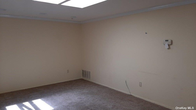 unfurnished room with crown molding, carpet flooring, and baseboards