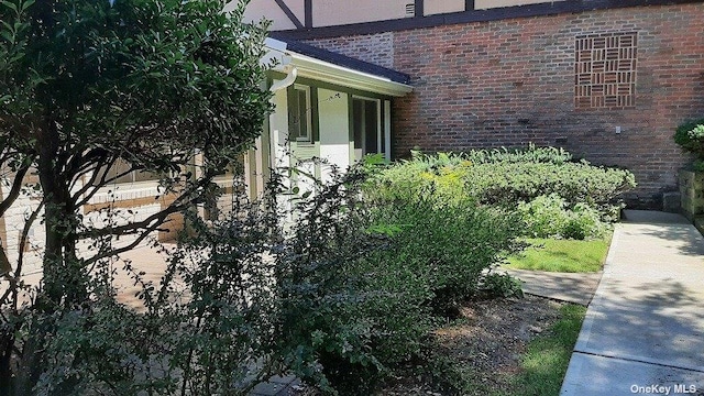 view of side of home with brick siding