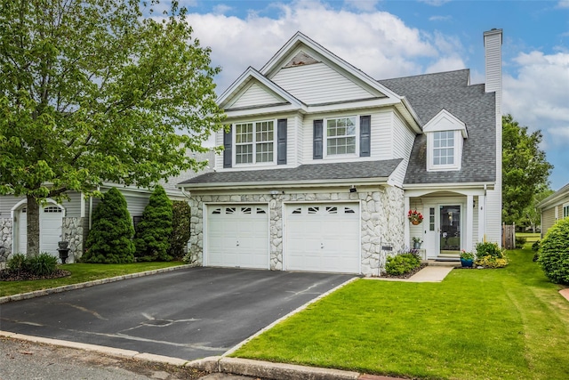 40 Ethan Cir, Middle Island, NY 11953 - traditional home with driveway, stone siding, a front yard, an attached garage, and a chimney