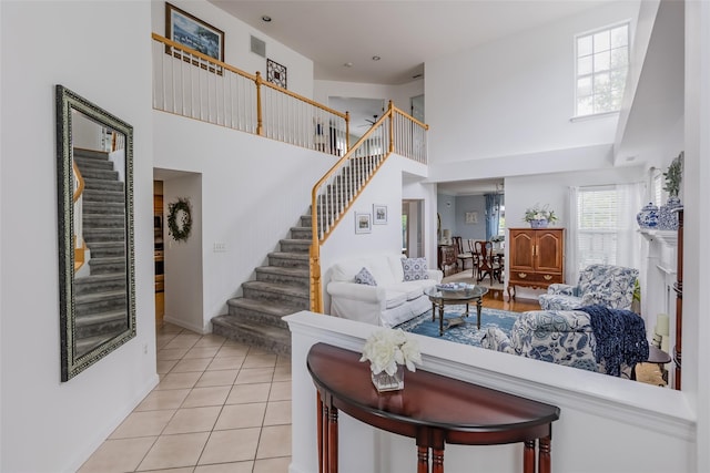 40 Ethan Cir, Middle Island, NY 11953 - living room with a towering ceiling, stairs, and light tile patterned flooring