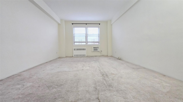 160-10 89th Ave Unit 9A, Jamaica, NY 11432 - carpeted empty room with radiator and an AC wall unit
