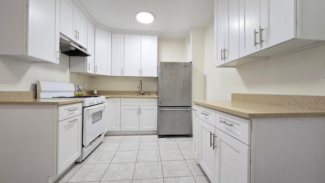 160-10 89th Ave Unit 9A, Jamaica, NY 11432 - kitchen featuring white gas range, freestanding refrigerator, under cabinet range hood, a sink, and white cabinetry