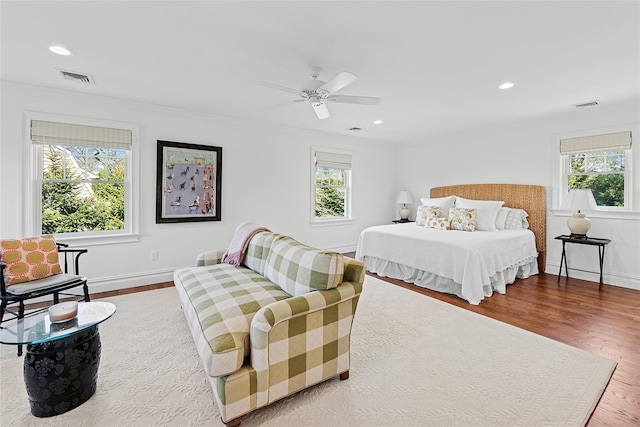 bedroom featuring multiple windows, wood finished floors, ornamental molding, recessed lighting, and a ceiling fan