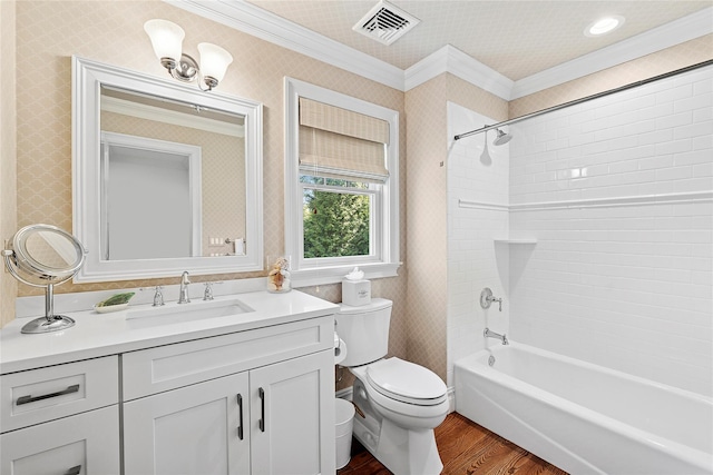 full bathroom with ornamental molding, wood finished floors, toilet, vanity, and shower / bathtub combination