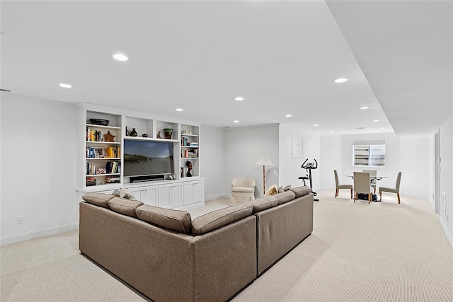 living room featuring light colored carpet, recessed lighting, and baseboards