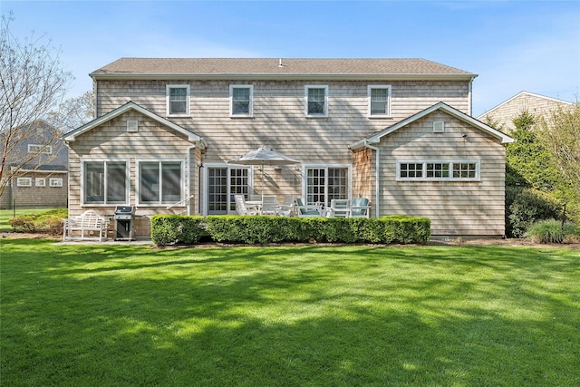 back of property featuring a yard and a patio area