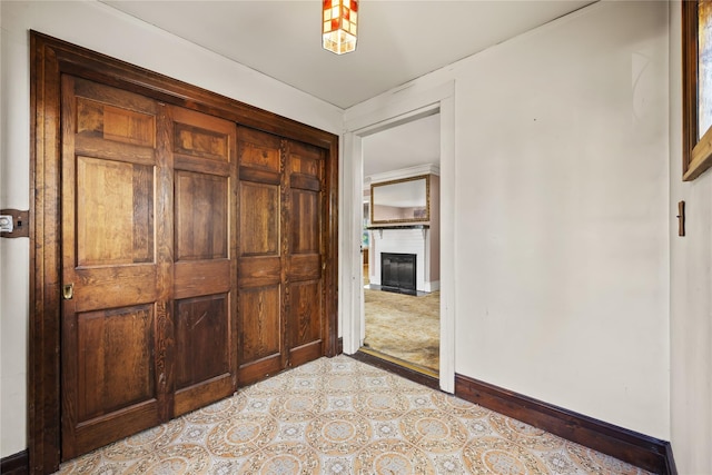 unfurnished bedroom with baseboards and a fireplace