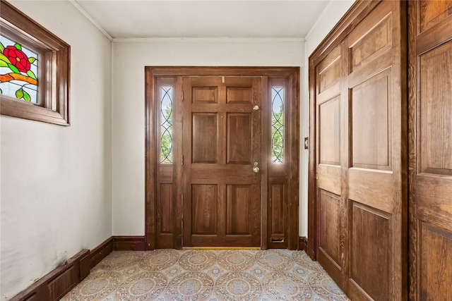 entrance foyer with healthy amount of natural light, baseboards, and ornamental molding