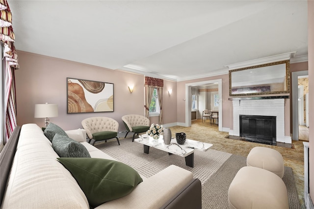 living room with ornamental molding, baseboards, and a fireplace