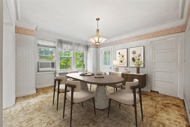 dining room featuring wallpapered walls, ornamental molding, cooling unit, light colored carpet, and baseboards