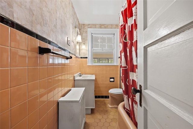 full bath with tile walls, tile patterned flooring, toilet, a shower with curtain, and vanity