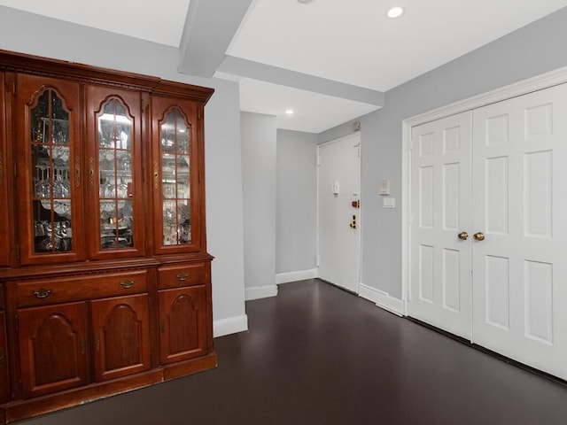 foyer entrance with baseboards, recessed lighting, and dark wood finished floors