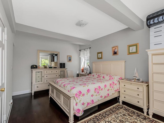 bedroom featuring multiple windows and dark wood-style floors