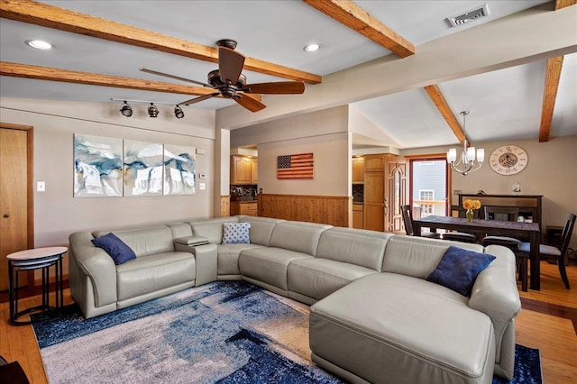 190 1st St, Buchanan, NY 10511 - living area featuring a chandelier, a wainscoted wall, wood walls, light wood-style flooring, and a ceiling fan