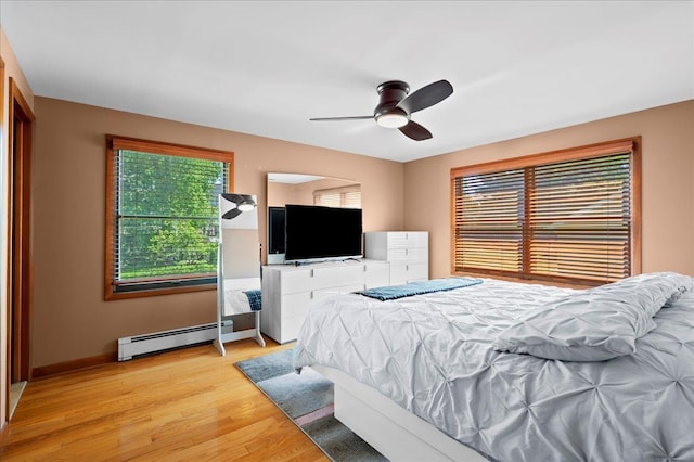 190 1st St, Buchanan, NY 10511 - bedroom featuring baseboard heating, light wood-style flooring, baseboards, and a ceiling fan