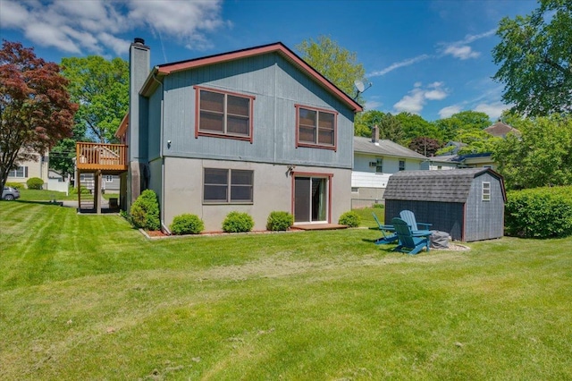 190 1st St, Buchanan, NY 10511 - rear view of house featuring a chimney, a deck, and a lawn