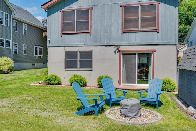 190 1st St, Buchanan, NY 10511 - rear view of property with a yard, stucco siding, and an outdoor fire pit