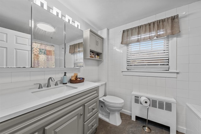 17 Sylvan Lake Rd, Lagrangeville, NY 12540 - bathroom with radiator, tile walls, toilet, vanity, and a shower with shower curtain