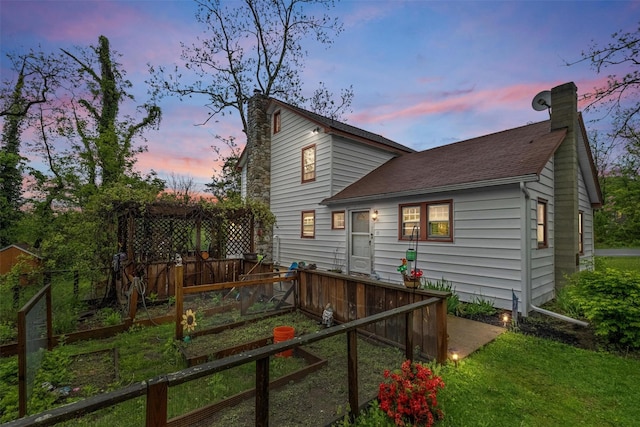 17 Sylvan Lake Rd, Lagrangeville, NY 12540 - back of property at dusk featuring a chimney and roof with shingles