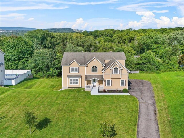 8 Tanyas Ct, Monroe, NY 10950 - traditional-style house featuring a view of trees, a front yard, and asphalt driveway