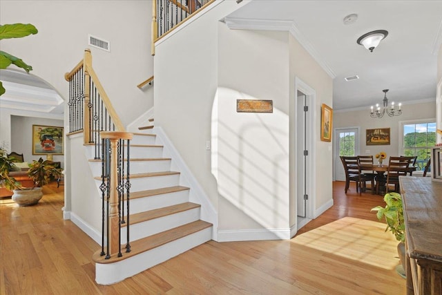 8 Tanyas Ct, Monroe, NY 10950 - stairway with wood finished floors, a chandelier, crown molding, and baseboards