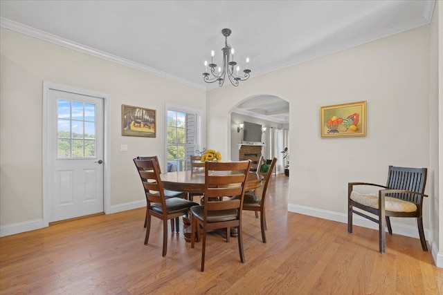 8 Tanyas Ct, Monroe, NY 10950 - dining space featuring arched walkways, a chandelier, baseboards, ornamental molding, and light wood-style floors