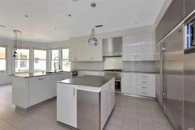 333 Baltustrol Cir, Roslyn, NY 11576 - kitchen with a sink, wall chimney exhaust hood, light tile patterned floors, and a kitchen island