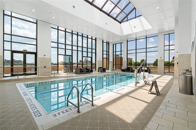indoor pool featuring a skylight