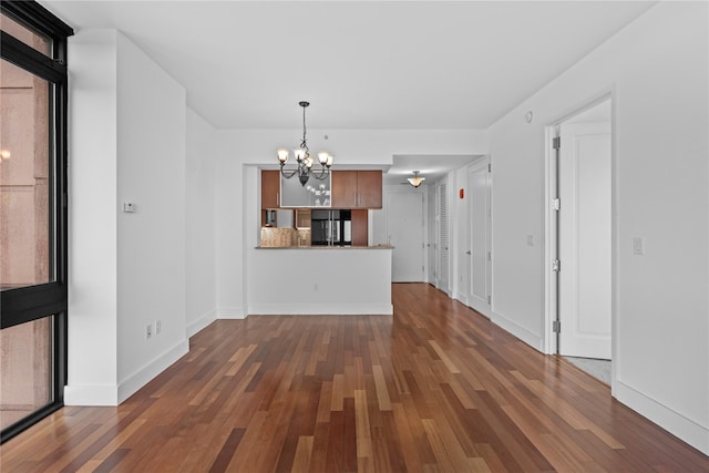 175 Huguenot St Unit 1808, New Rochelle, NY 10801 - unfurnished living room featuring a chandelier and dark wood-type flooring