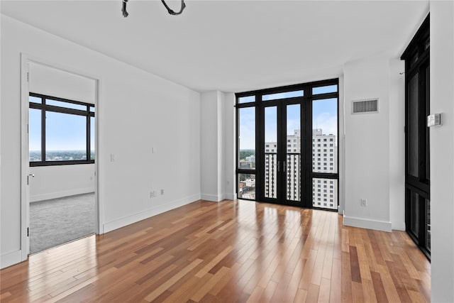 175 Huguenot St Unit 1808, New Rochelle, NY 10801 - spare room featuring light wood finished floors and baseboards