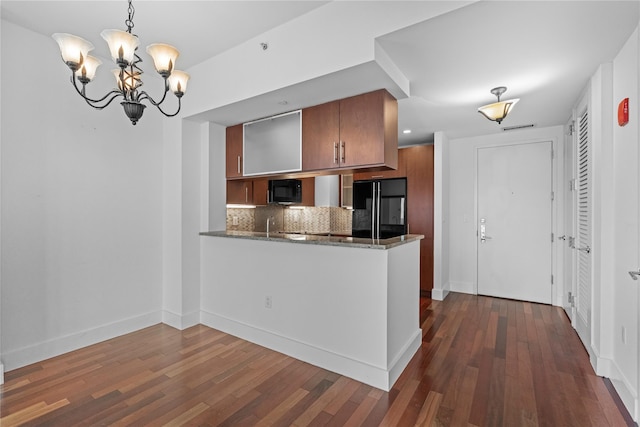 175 Huguenot St Unit 1808, New Rochelle, NY 10801 - kitchen featuring black appliances, tasteful backsplash, a chandelier, and dark wood-type flooring