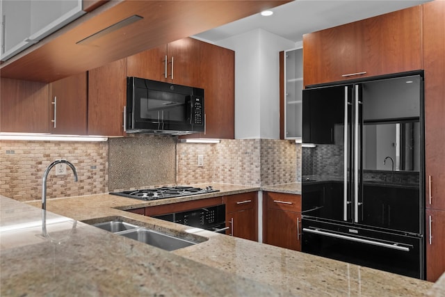 175 Huguenot St Unit 1808, New Rochelle, NY 10801 - kitchen with black appliances, light stone countertops, brown cabinets, and recessed lighting