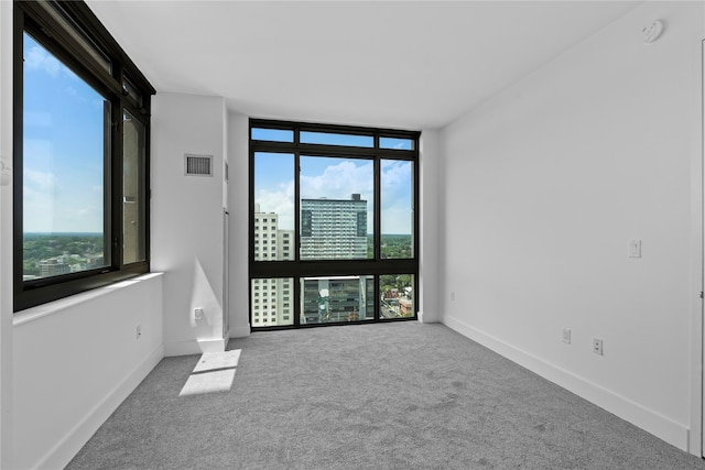 175 Huguenot St Unit 1808, New Rochelle, NY 10801 - spare room with carpet flooring, expansive windows, a smoke detector, and a view of city