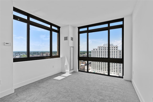 175 Huguenot St Unit 1808, New Rochelle, NY 10801 - carpeted empty room with a view of city and a wall of windows