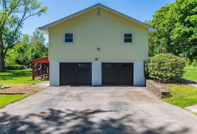 184 Cedar Valley Rd, Poughkeepsie, NY 12603 - view of property exterior featuring stairway, asphalt driveway, an attached garage, and a lawn